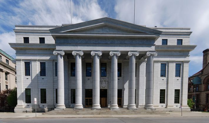 The west facade of the New York Court of Appeals building in Albany, with a classical pediment over fluted ionic columns.