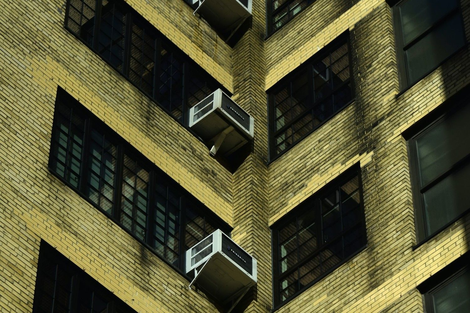 Air conditioners in a brick building.