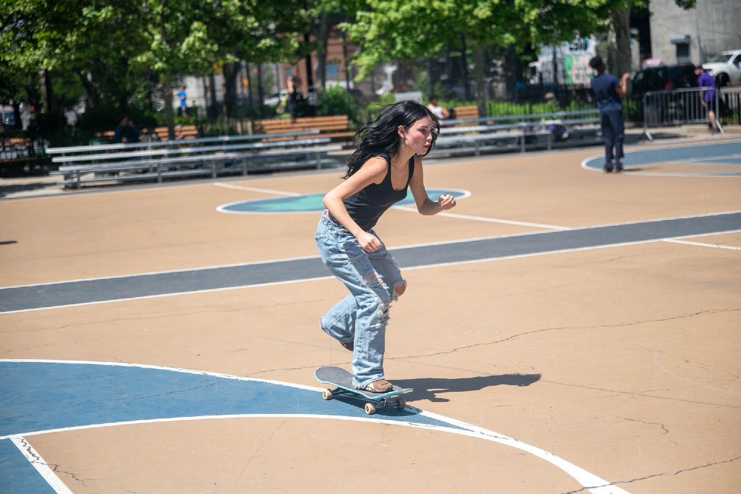 Bryan pushes off the ground with her left foot while skating.