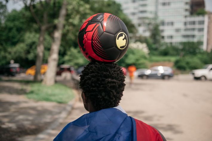 Leh-Boy balances a ball on his head.