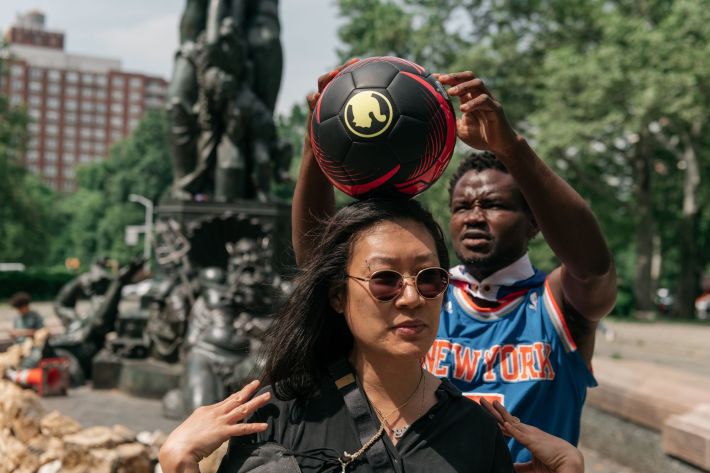 Leh-Boy tries to show this reporter how to balance by putting a soccer ball on her head.