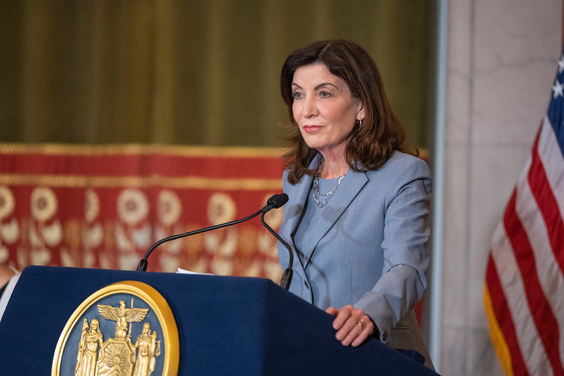 Governor Kathy Hochul stands at a podium and takes questions about the legislature's extraordinary session.