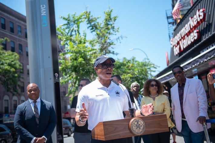 Mayor Eric Adams, in a white polo shirt, sunglasses, and a baseball cap, at a press conference announcing new 5G LinkNYC service in the Bronx on Sunday, July 10, 2022.