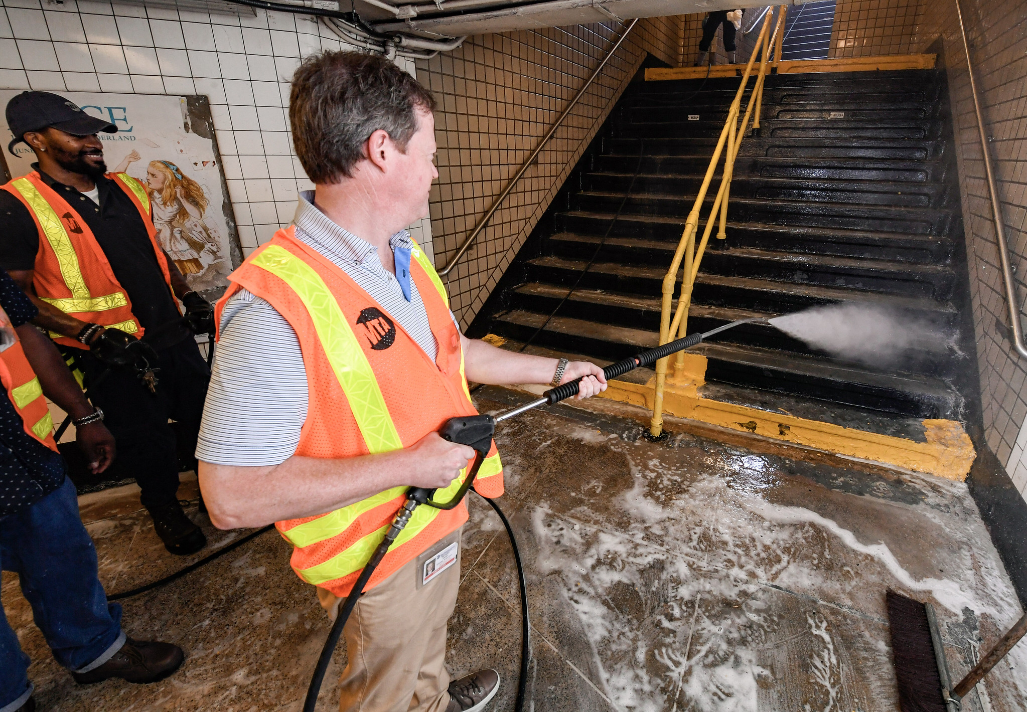 MTA New York City Transit President Richard Davey and Senior Vice President of Subways Demetrius Crichlow hose down a subway stairwell.