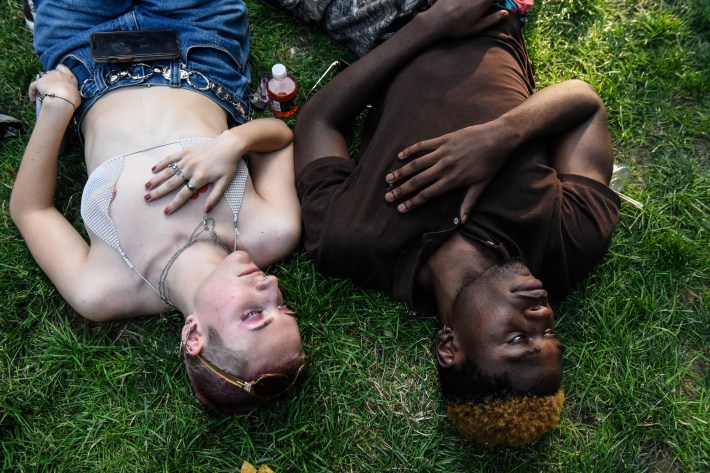 Two people lay in the grass.