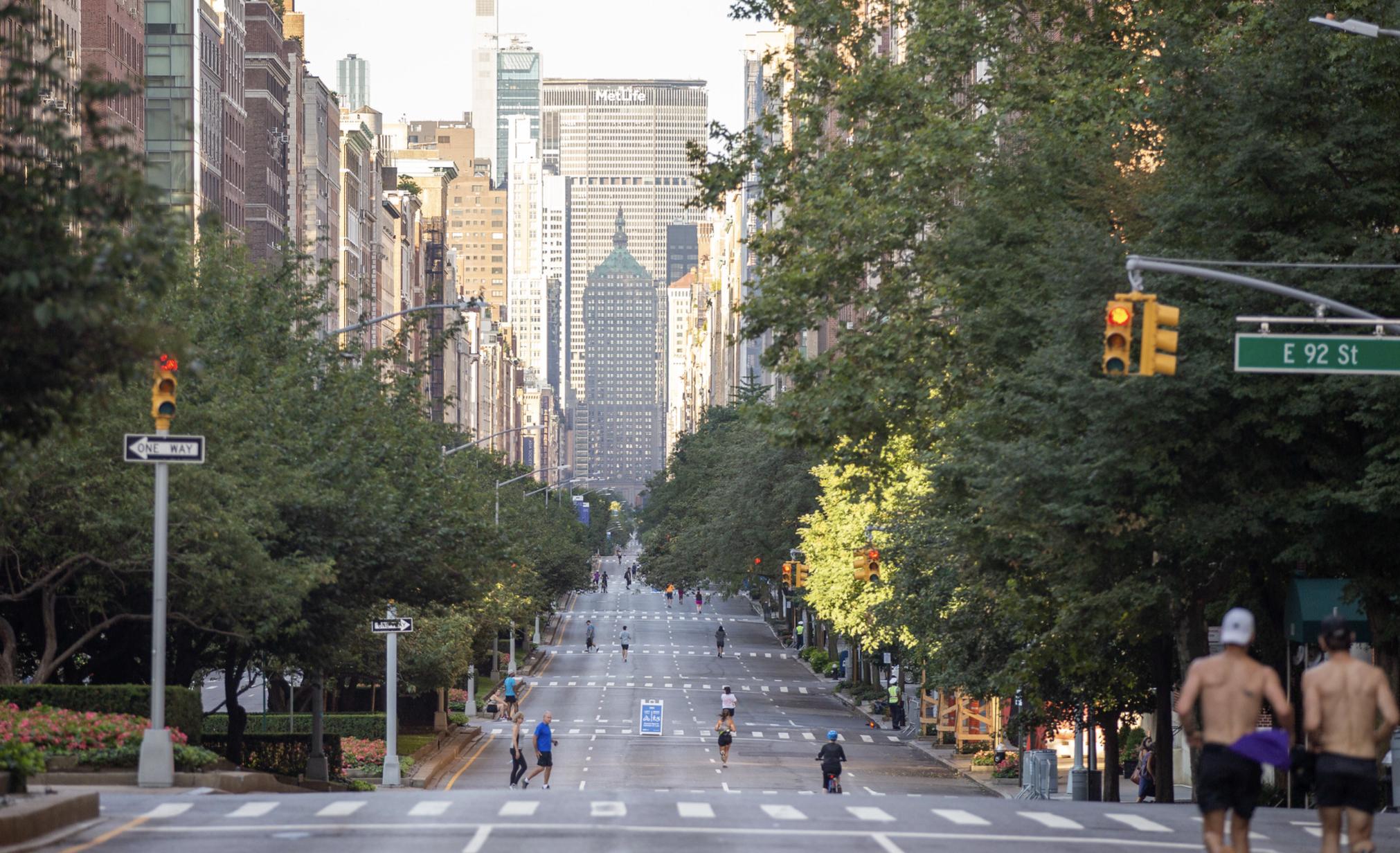 Two runners run on an empty Park Avenue during Summer Streets.