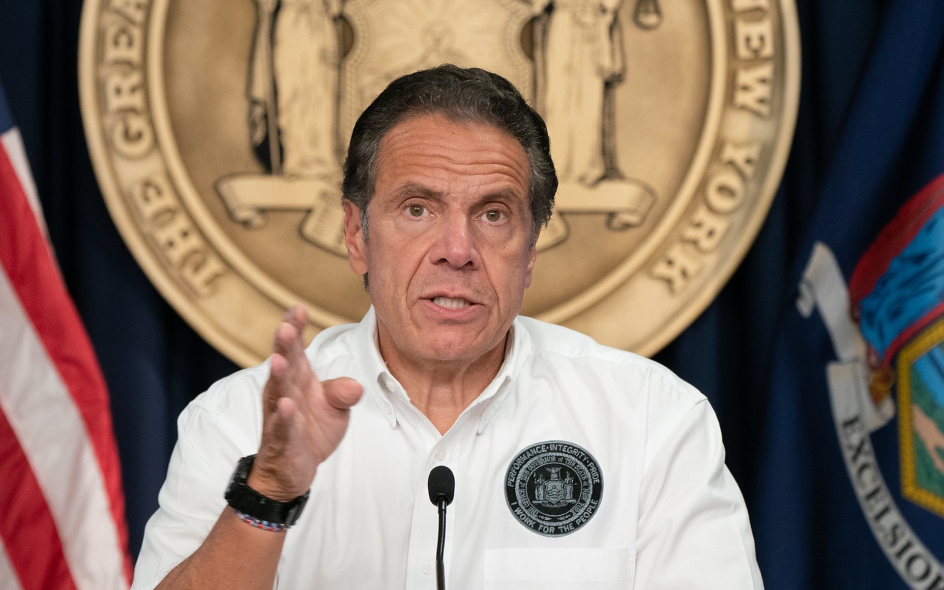 Former NY Governor Andrew Cuomo, in a white polo shirt, points his finger at the camera
