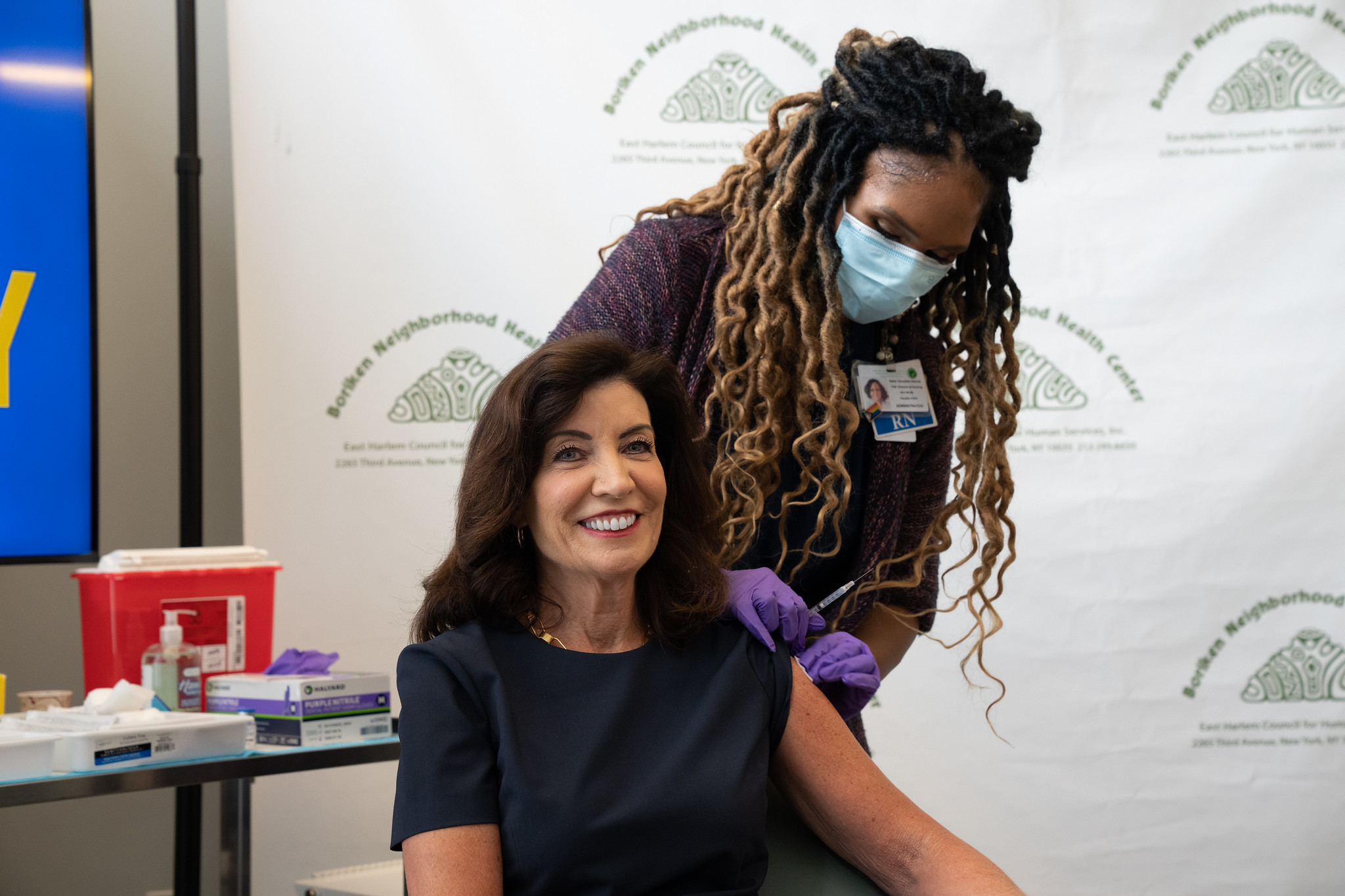 Governor Kathy Hochul receives a new COVID booster from a nurse wearing a mask at a clinic in East Harlem on Wednesday.
