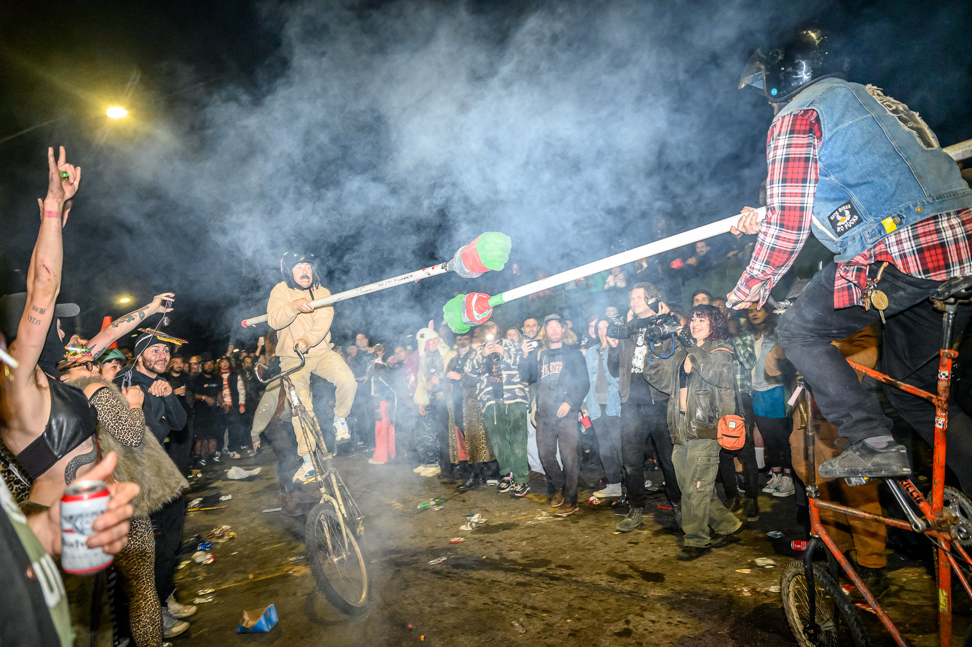 Two cyclists on tall bikes during the Bike Kill joust on October 29, 2022.