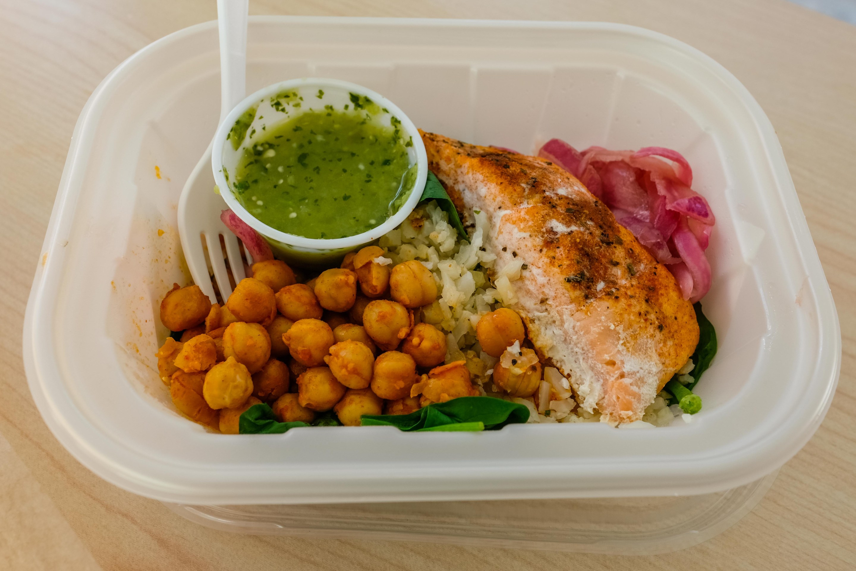 Chickpeas, sauce, and salmon sit in a tray at the Everytable in Flatbush.
