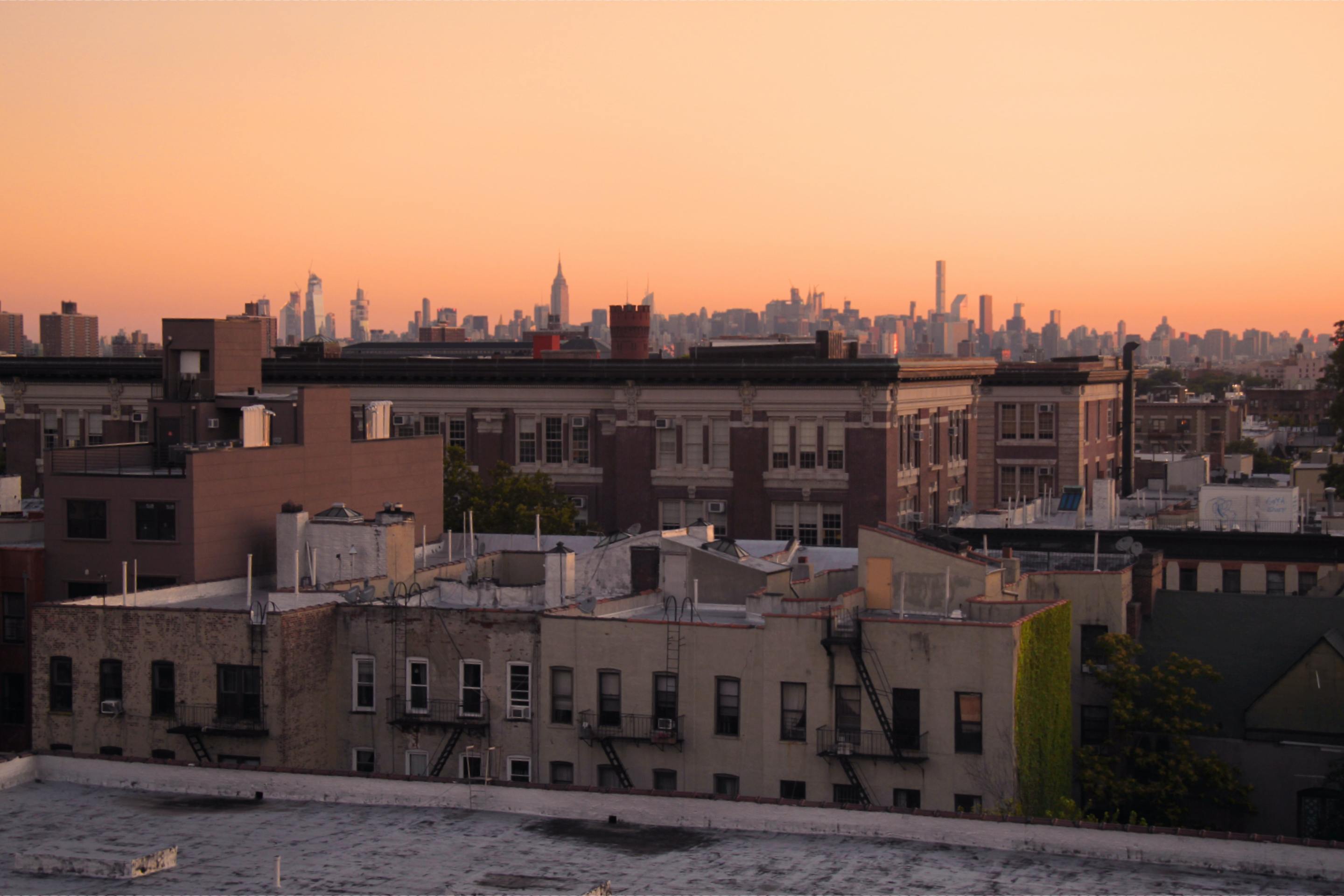 Sunrise over New York City tenements in Brooklyn, looking towards the Manhattan skyline