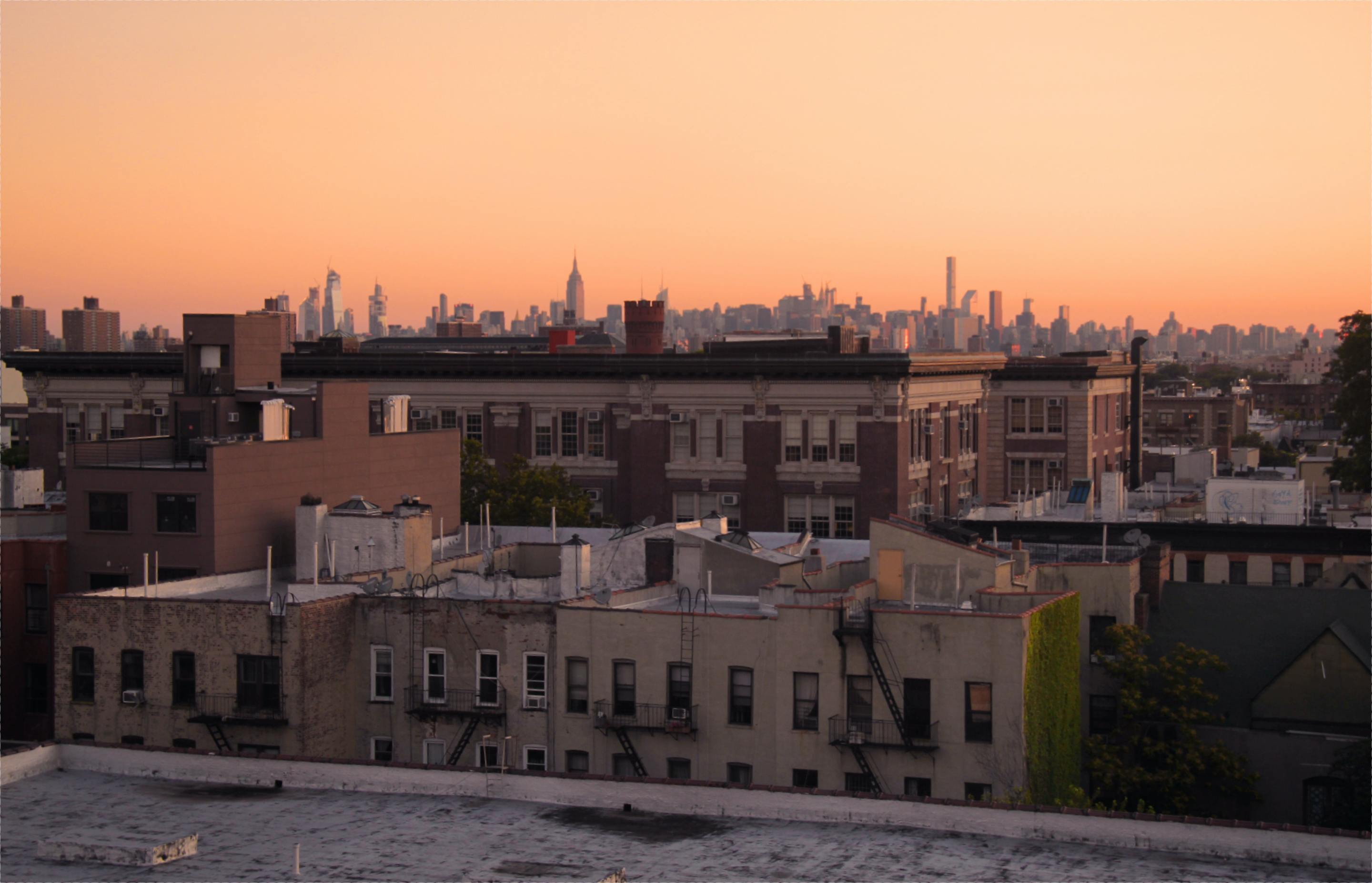 Sunrise over New York City tenements in Brooklyn, looking towards the Manhattan skyline