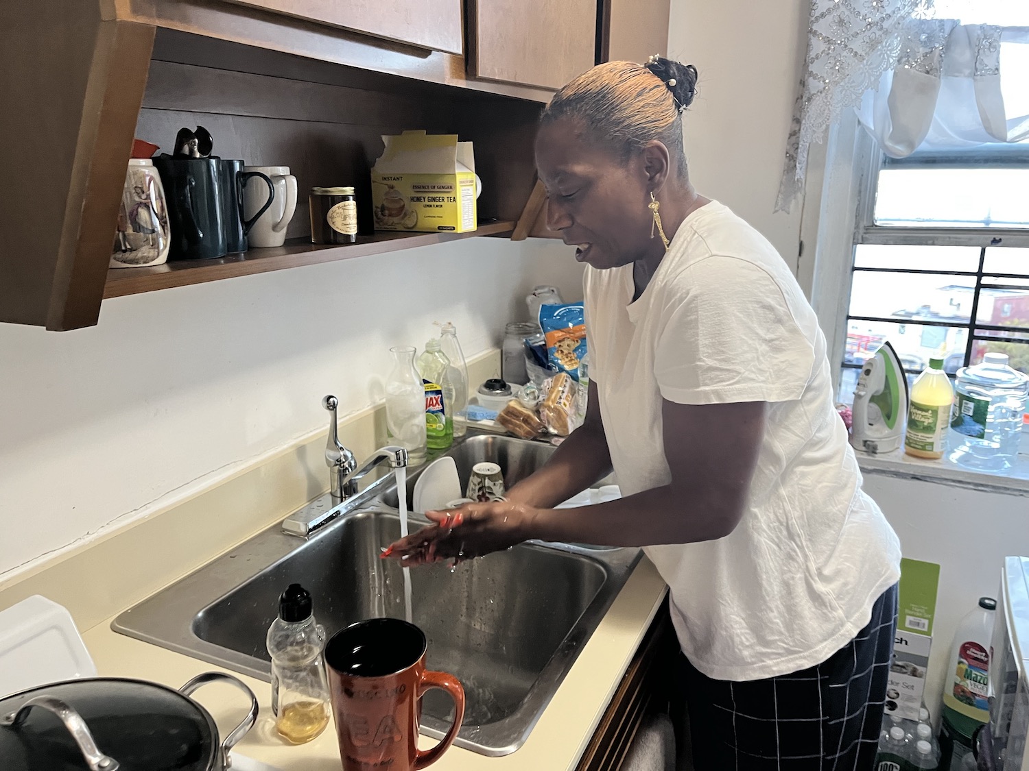 For years, Bridget Tuck has only used her tap water for washing her hands, bathing, and occasionally to help her swallow medication. Here she is, washing her hands in her kitchen sink.