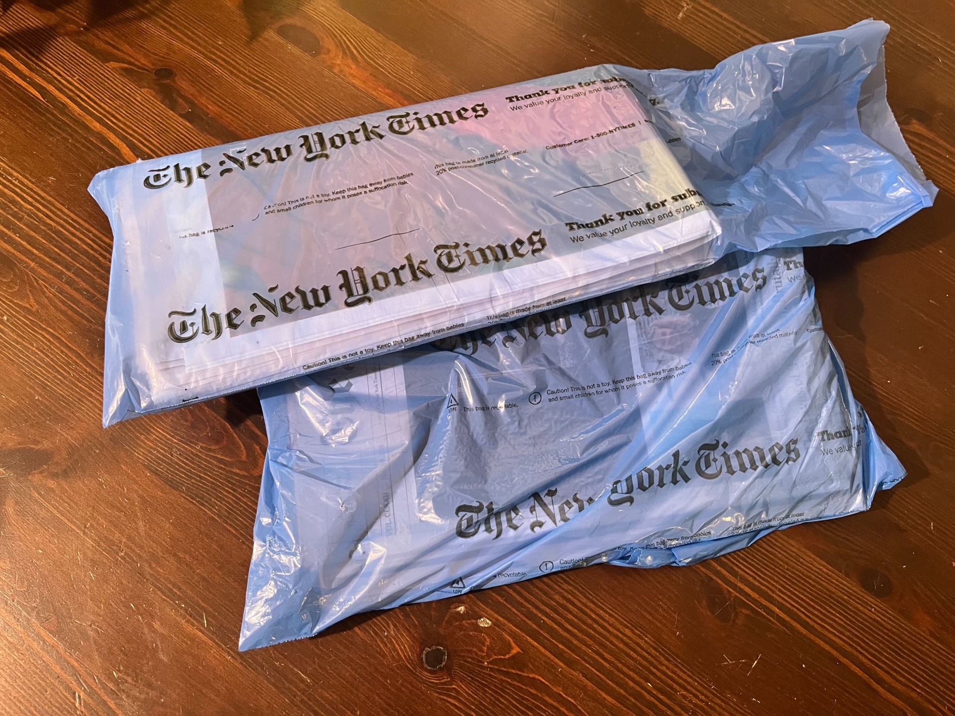 Two unopened editions of the New York Times.