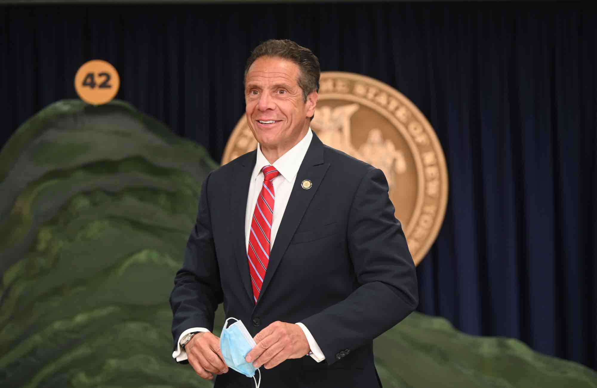 Cuomo stands in front of his giant foam mountain that represented dead New Yorkers.