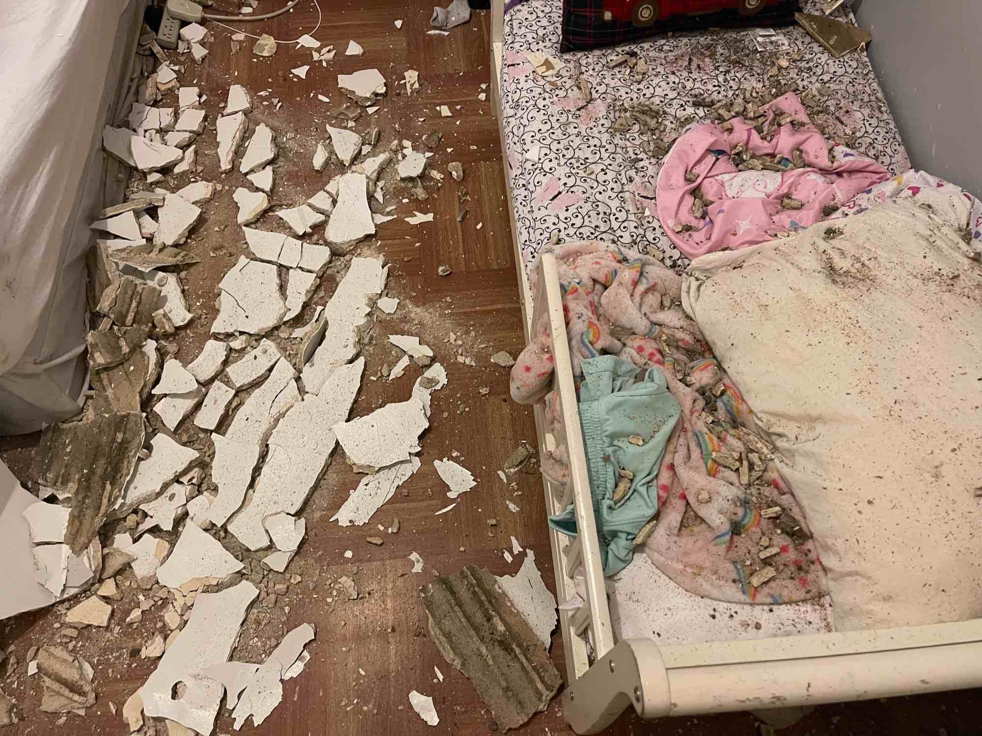 Plaster chunks atop a child's bed at 709 West 170th Street (courtesy of 709 West 170th Street Tenants Association)