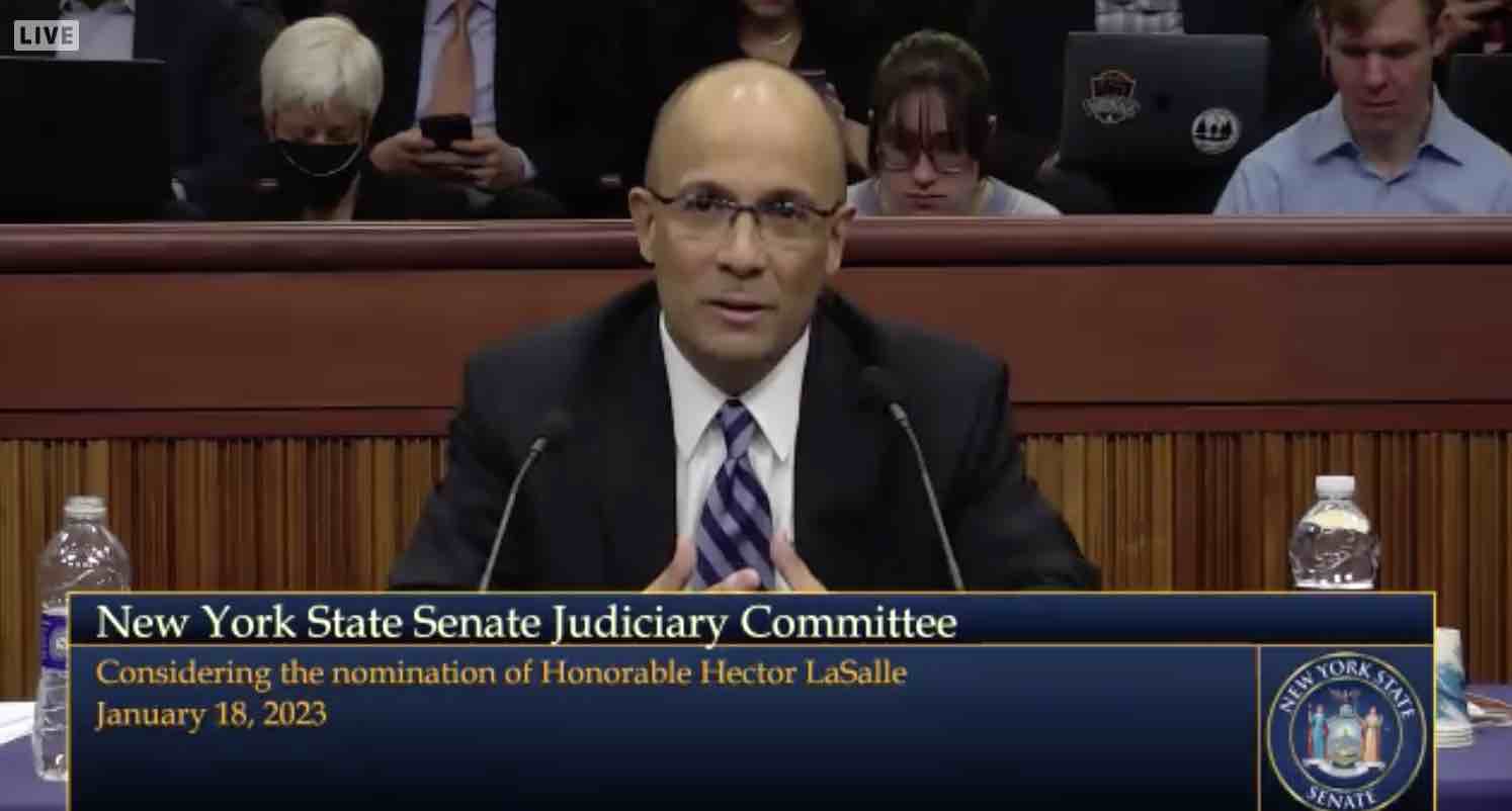 Judge Hector LaSalle in a suit, testifying during a state senate committee hearing.