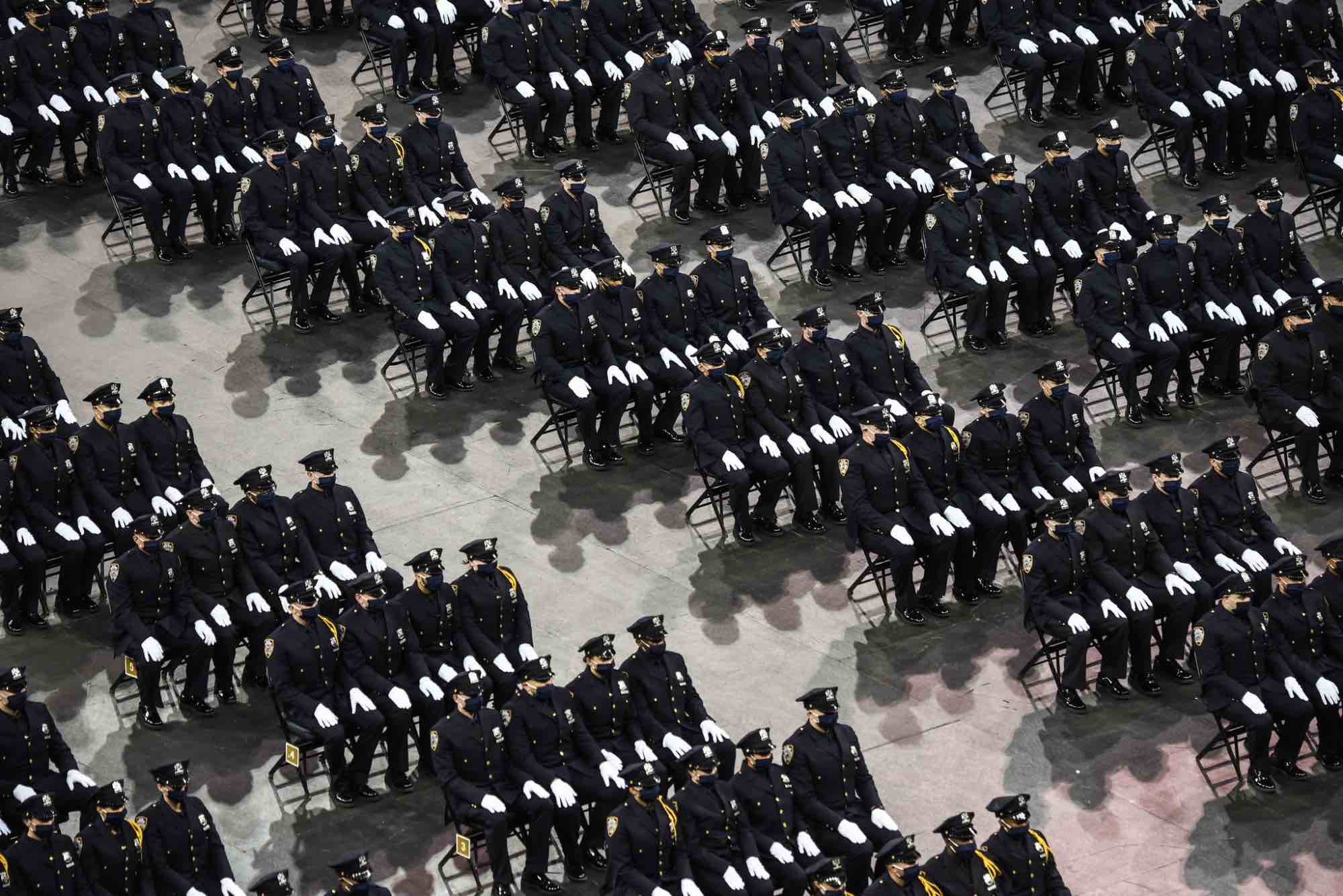 Rows and rows of uniformed police officers at an NYPD graduation ceremony in 2021.