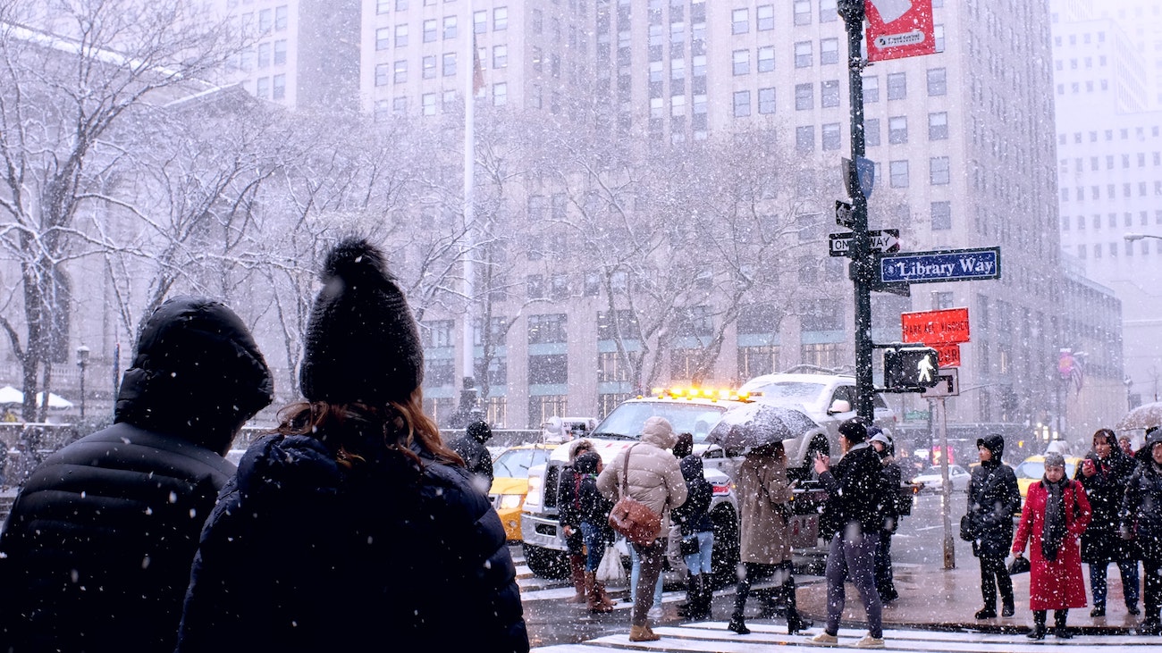 A NYC Midtown streetscape with snowfall.