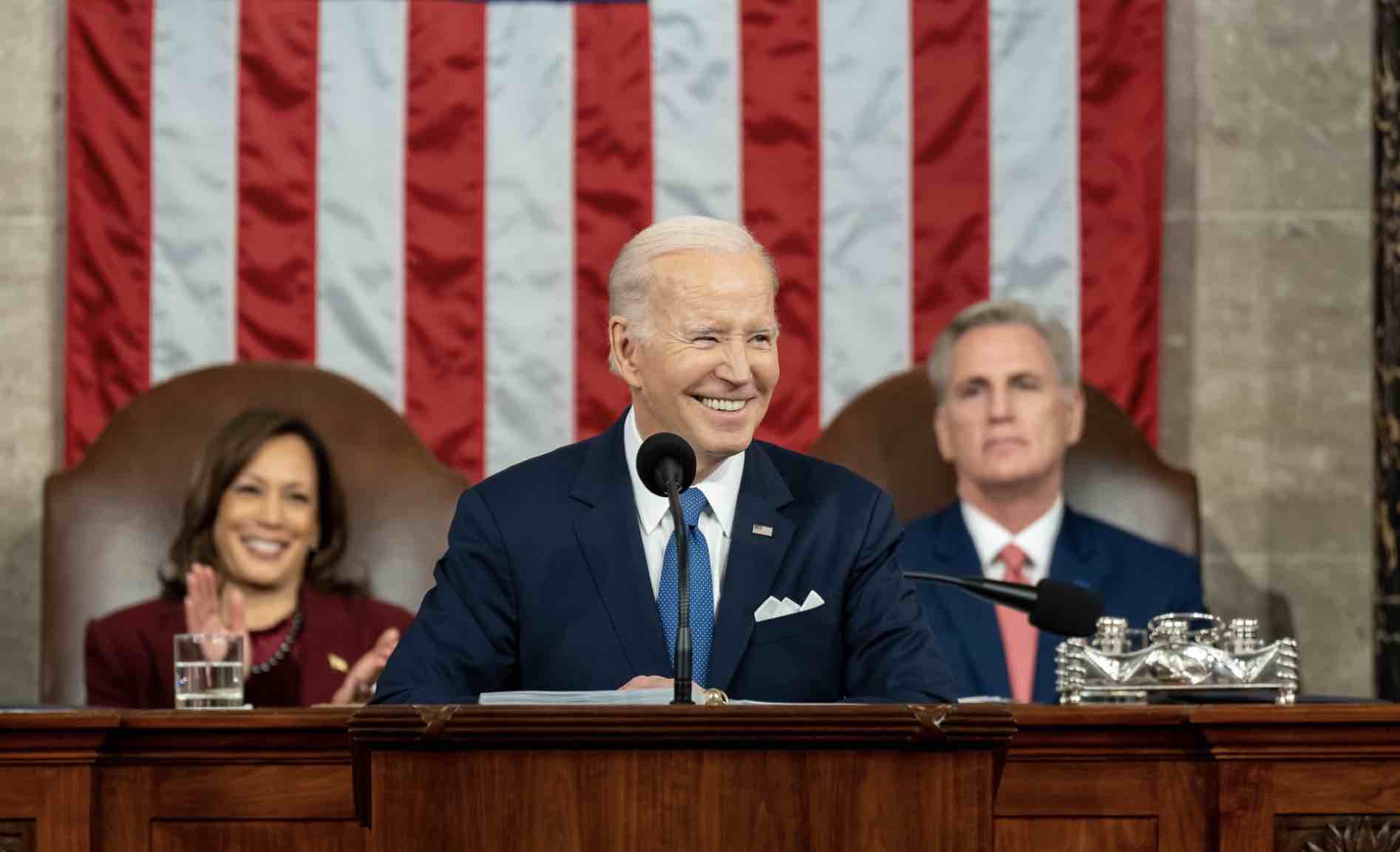 President Biden stands between Vice President Kamala harris and Speaker of the House Kevin McCarthy while delivering his state of the union speech.