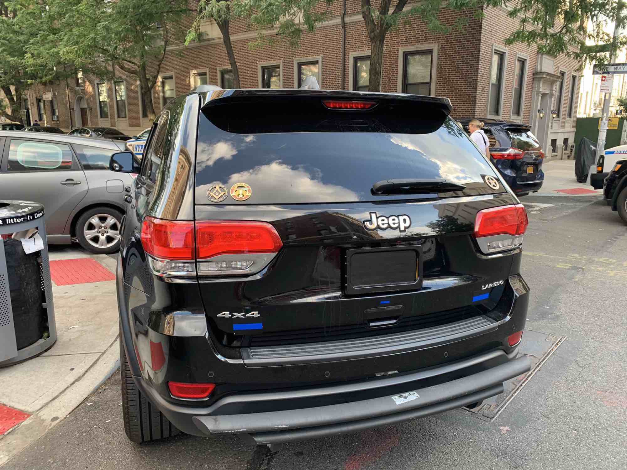 A black Jeep with an illegal plate obstruction device driven by the Brooklyn director of the Mayor's Community Affairs Unit.