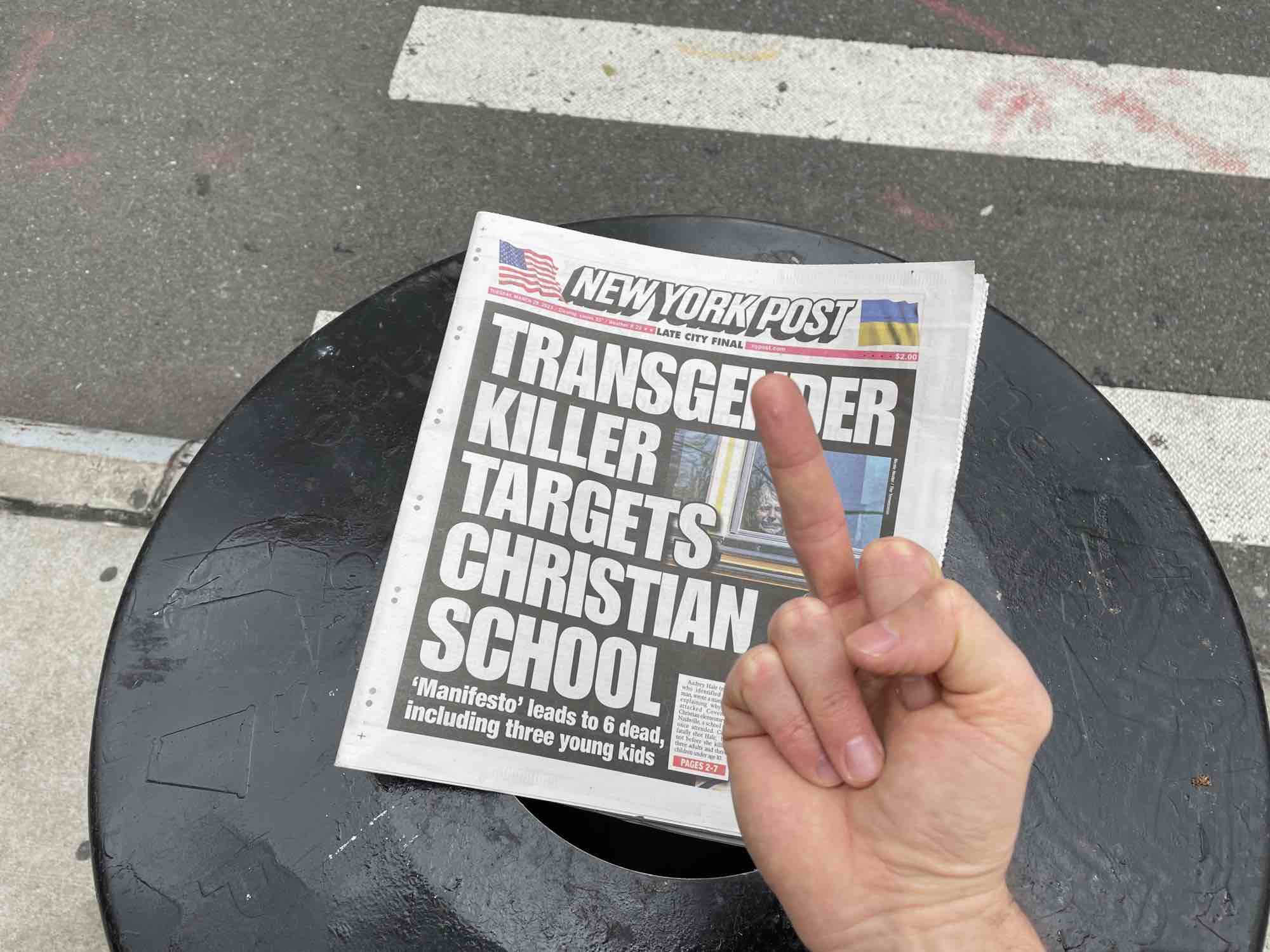 A middle finger over an offensive NY Post cover.