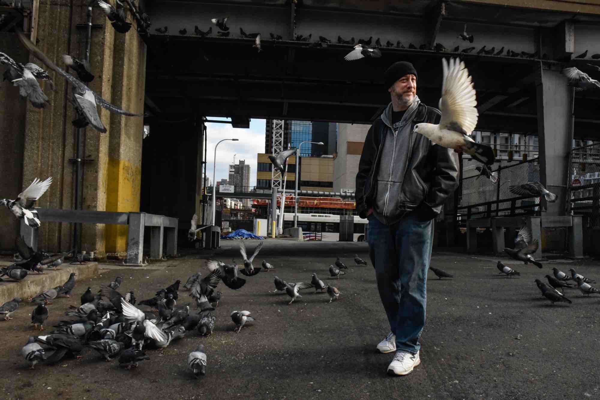 John Painz with a colony of pigeons on the west side of the Lincoln Tunnel area while on pigeon patrol in Manhattan, New York, U.S., February 24, 2023. (Stephanie Keith / Hell Gate)