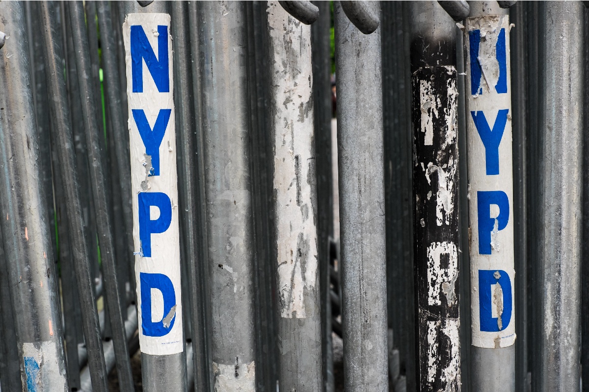 A police barricade with NYPD stickers.