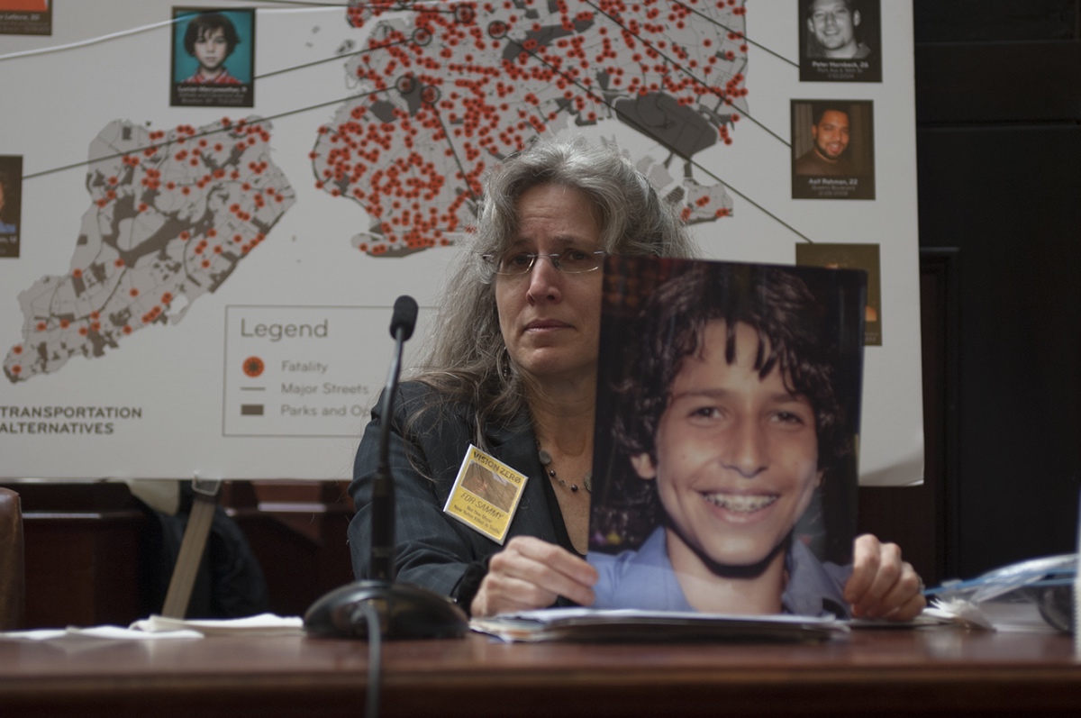 Amy Cohen testifies at a City Council hearing in 2014, holding a photo of her son Sammy, who was killed by a speeding van driver in 2013 (Photo: City Council)