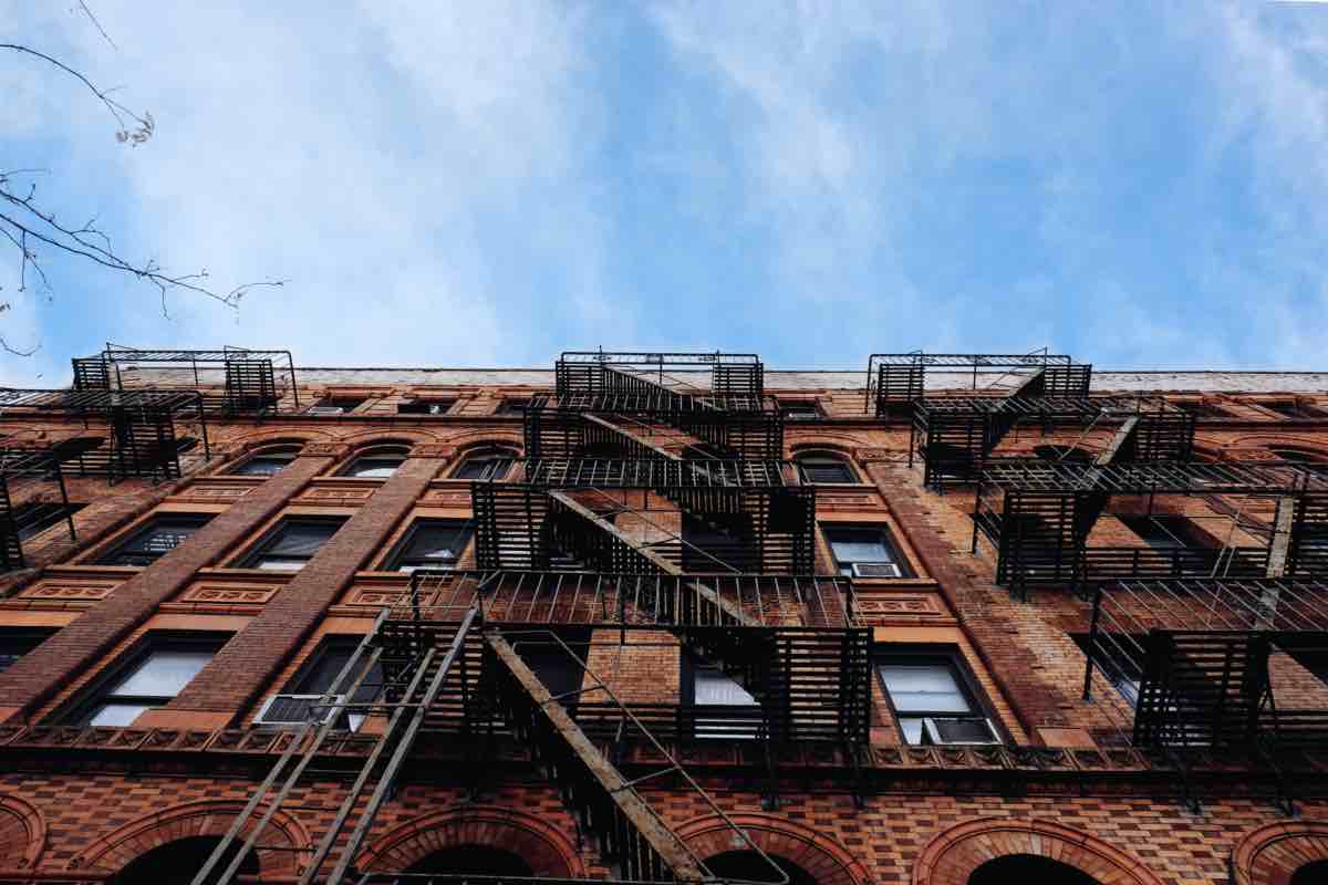 A view of a NYC fire escape with AC units next to it.