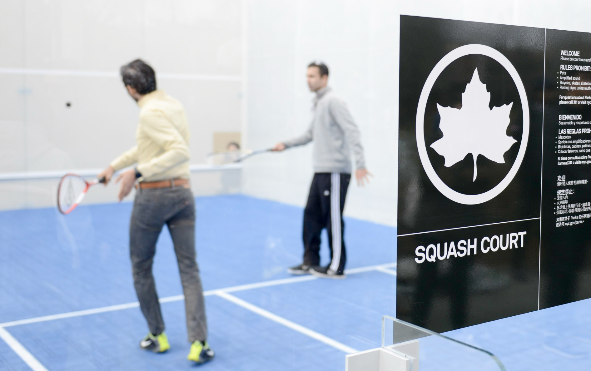 Two people play squash in NYC Parks' first and only free outdoor squash court.