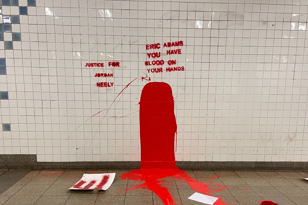 Graffiti at the Broadway-Lafayette Station in Manhattan that reads "JUSTICE FOR JORDAN NEELY" and "ERIC ADAMS YOU HAVE BLOOD ON YOUR HANDS" in red paint