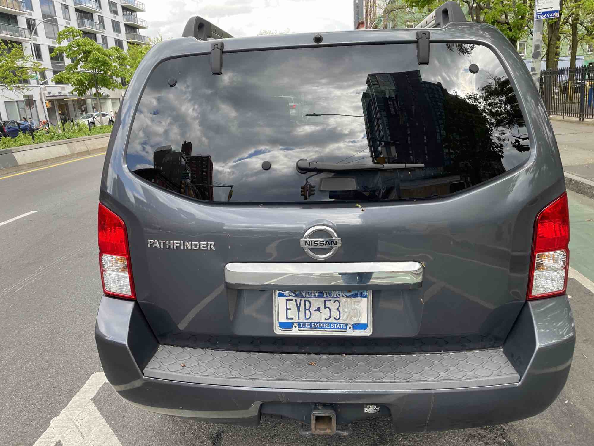 An SUV with a defaced license plate.