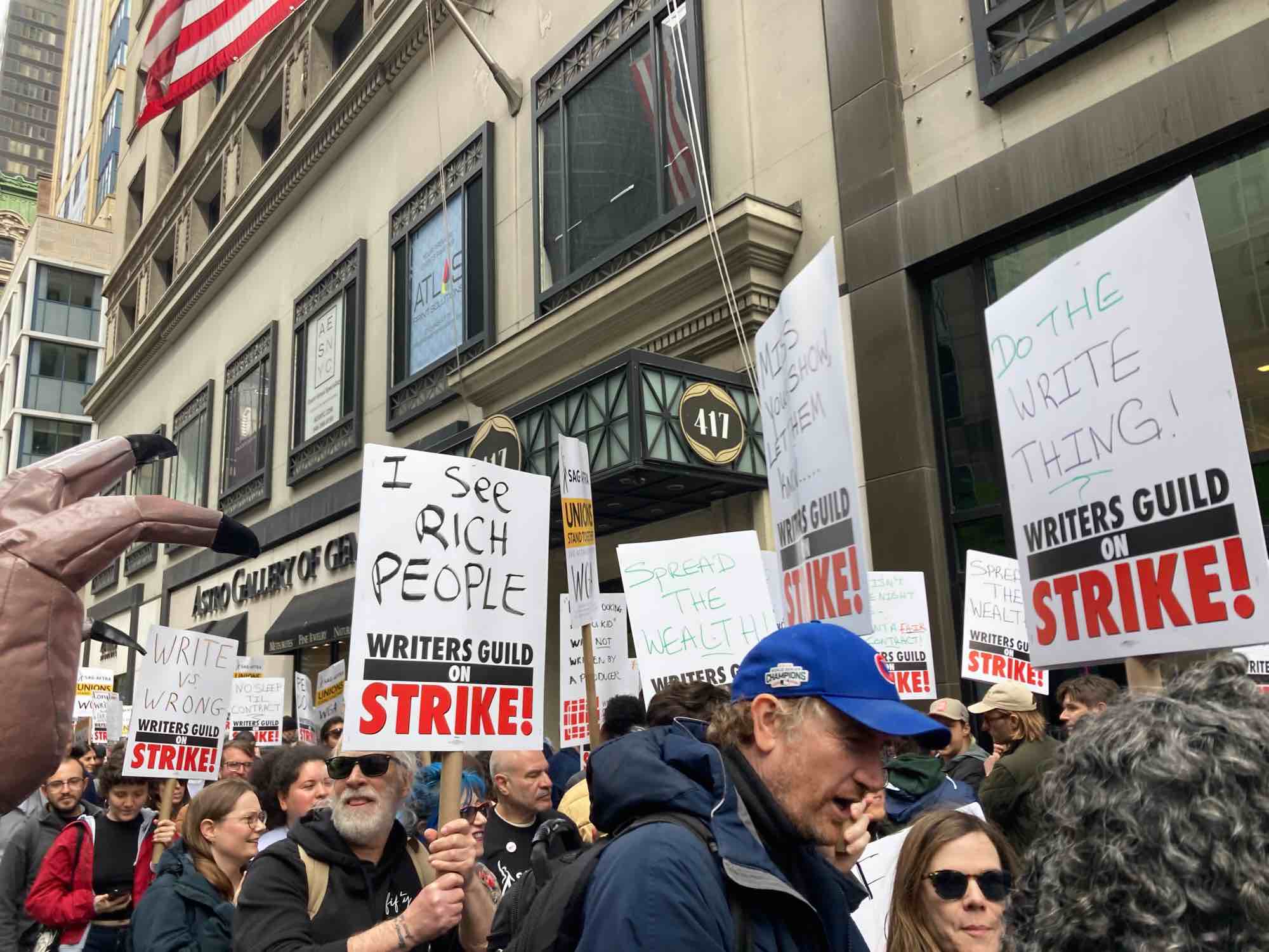 Striking writers hold signs and picket in Midtown.