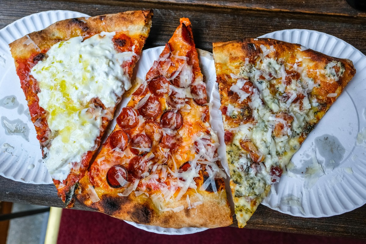 Slices of burrata, pepperoni, and chicory pizza from Funzi's Pizzeria in New York City.