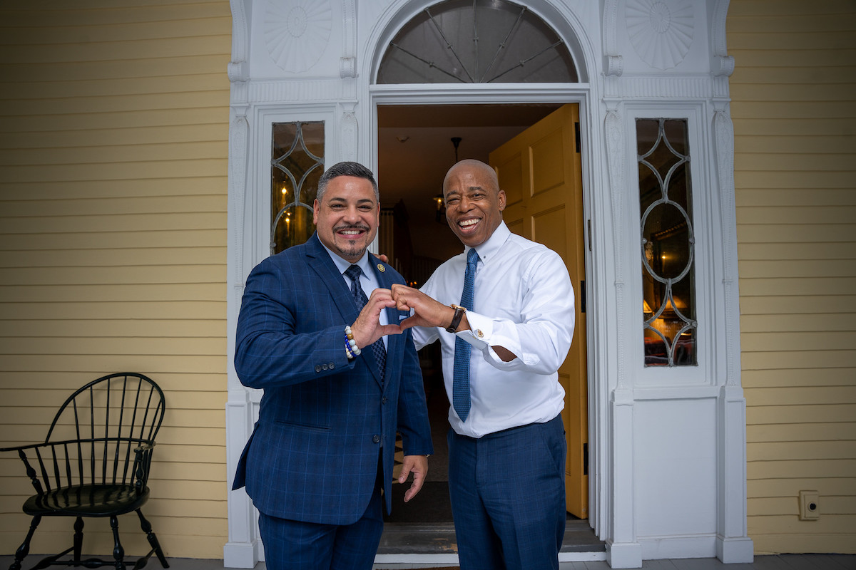 NYPD Commissioner Edward Caban and Mayor Eric Adams make a heart with their hands at Gracie Mansion.