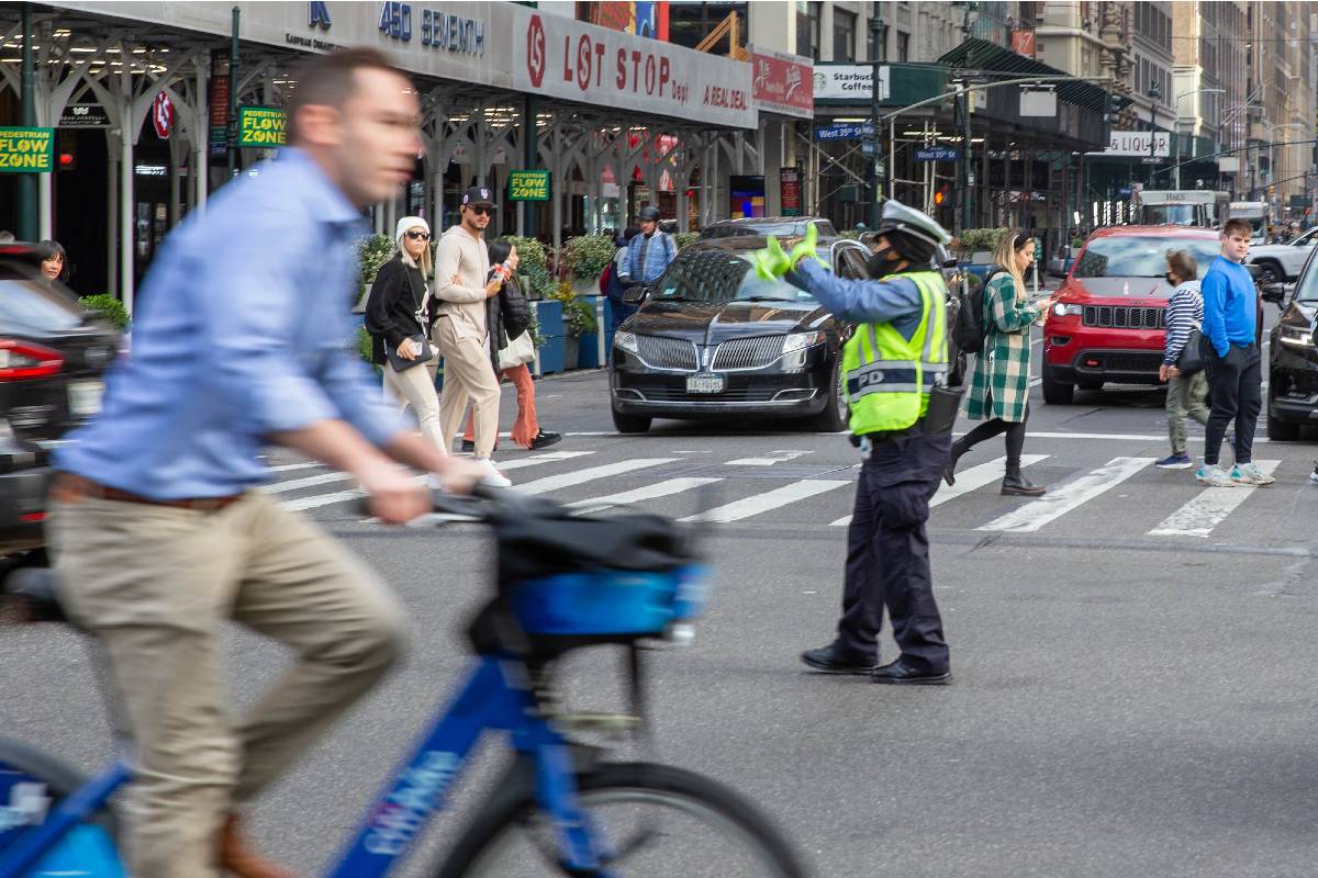A cyclist navigates a busy city street