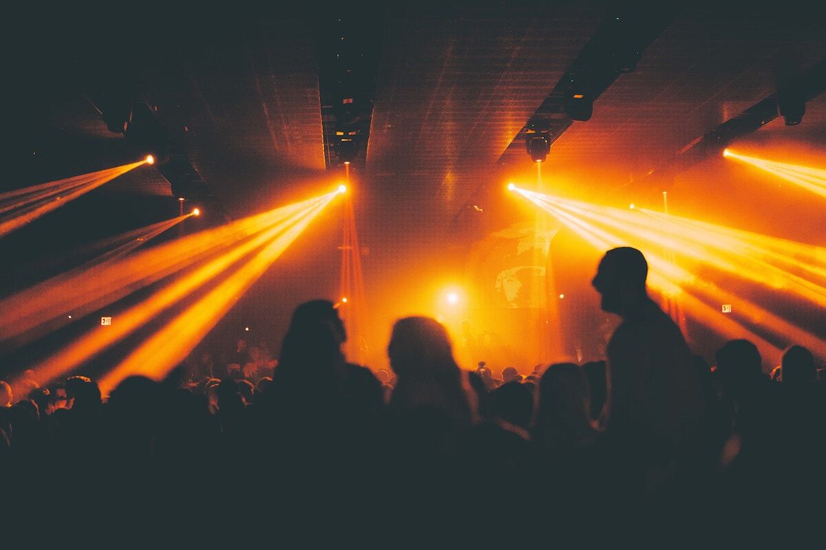 Orange lights inside of a dark nightclub.