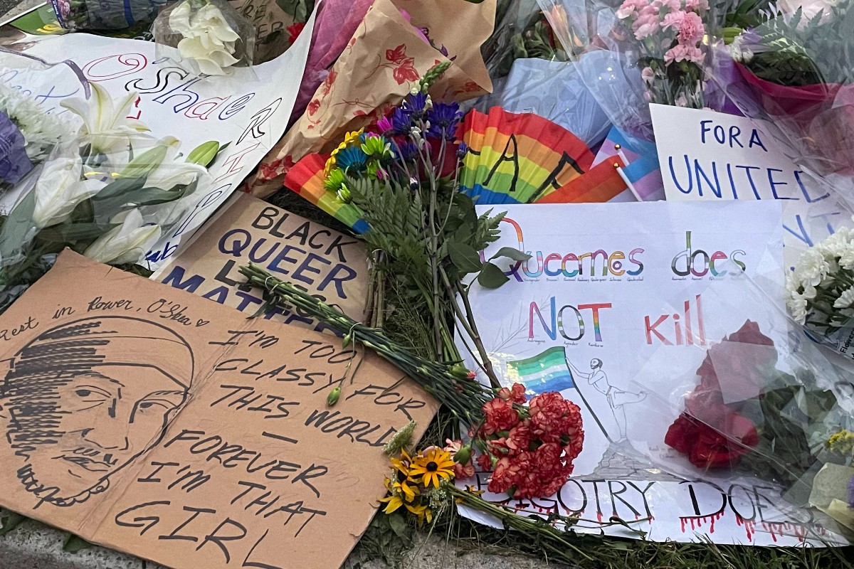 Signs and flowers for O'Shae Sibley at a vigil in his honor on August 4, 2023.