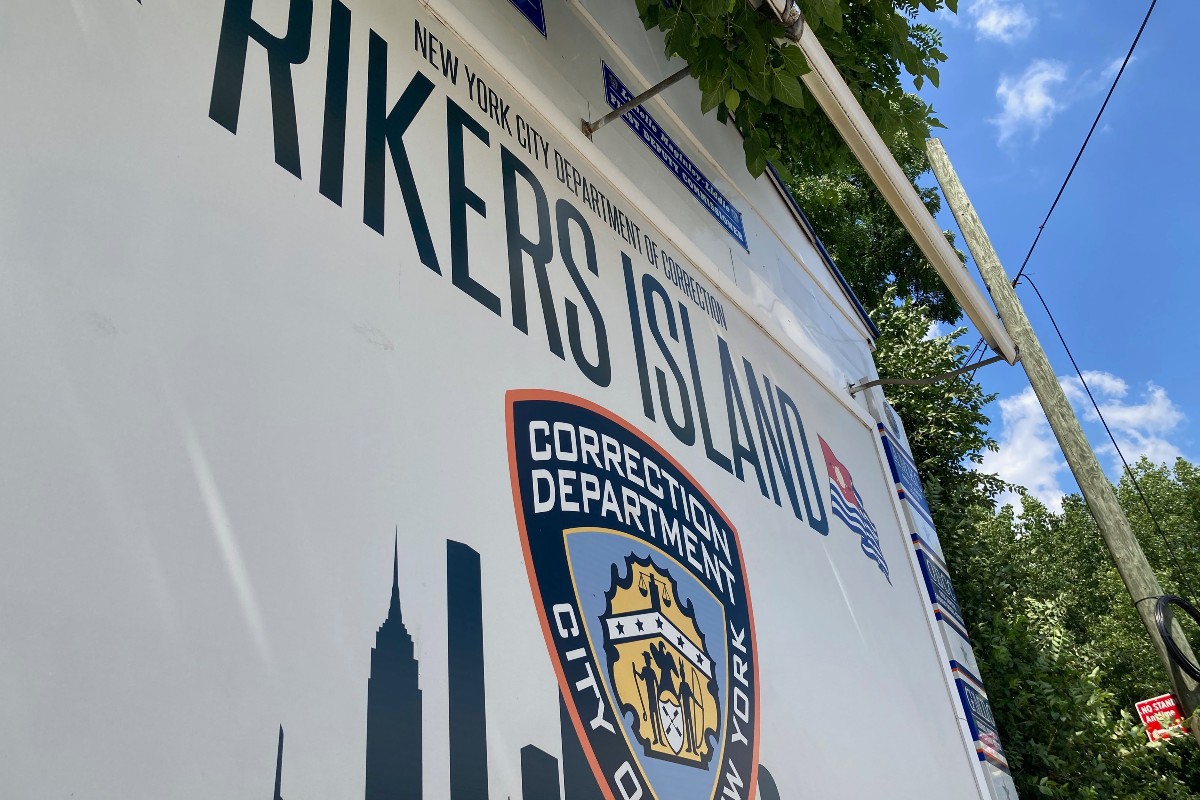 A shot of the sign in front of Rikers Island.
