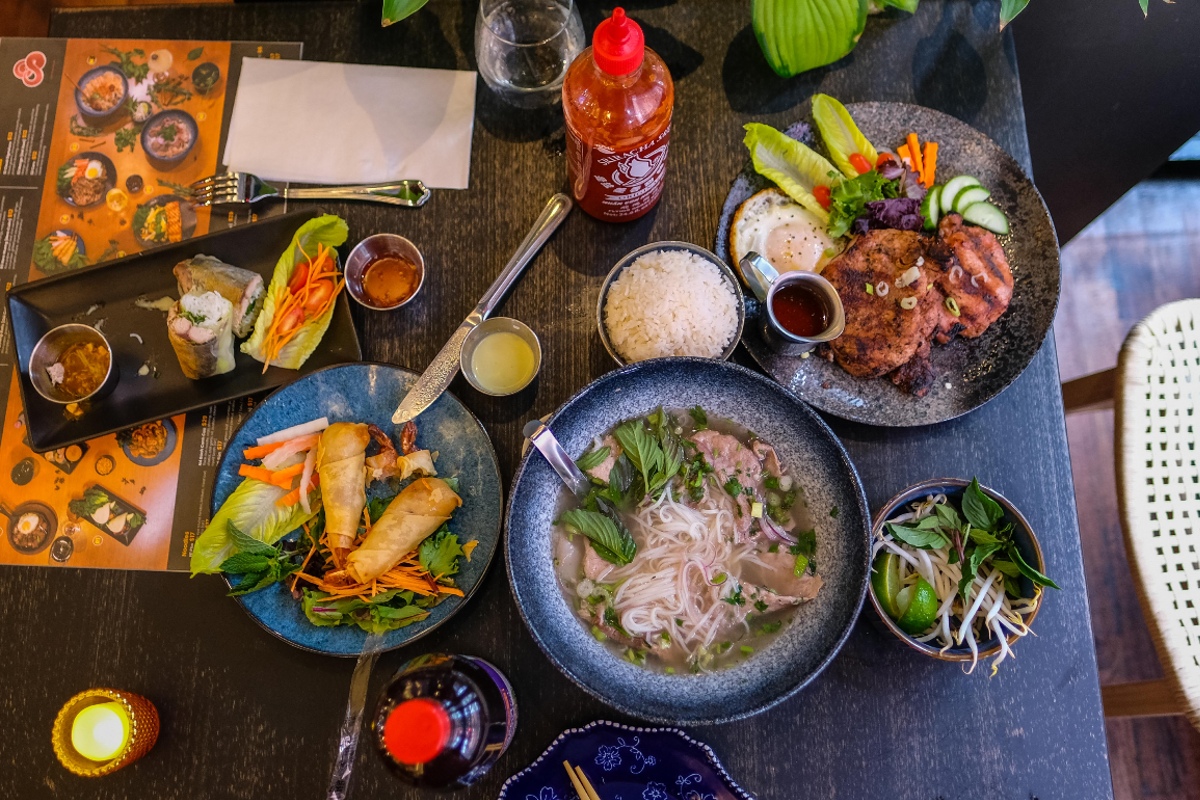 A table filled with classic Vietnamese dishes.
