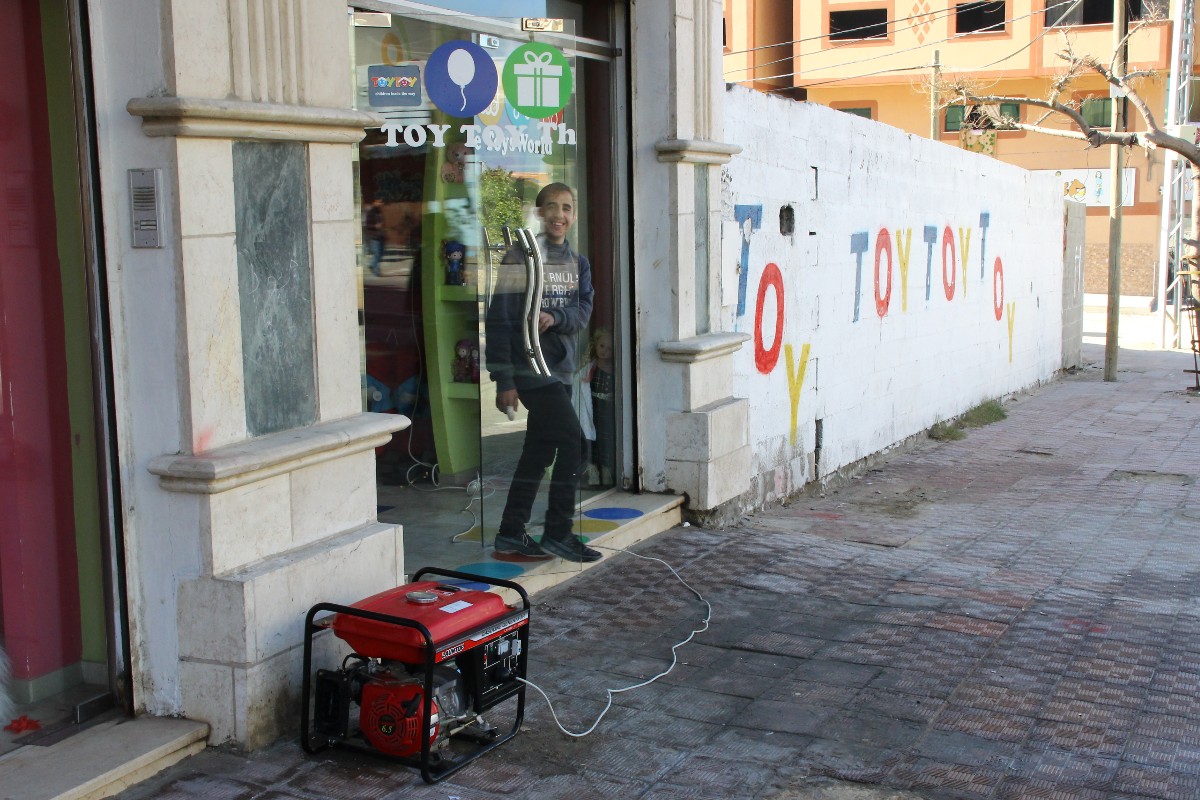 A child exits a storefront in Gaza.