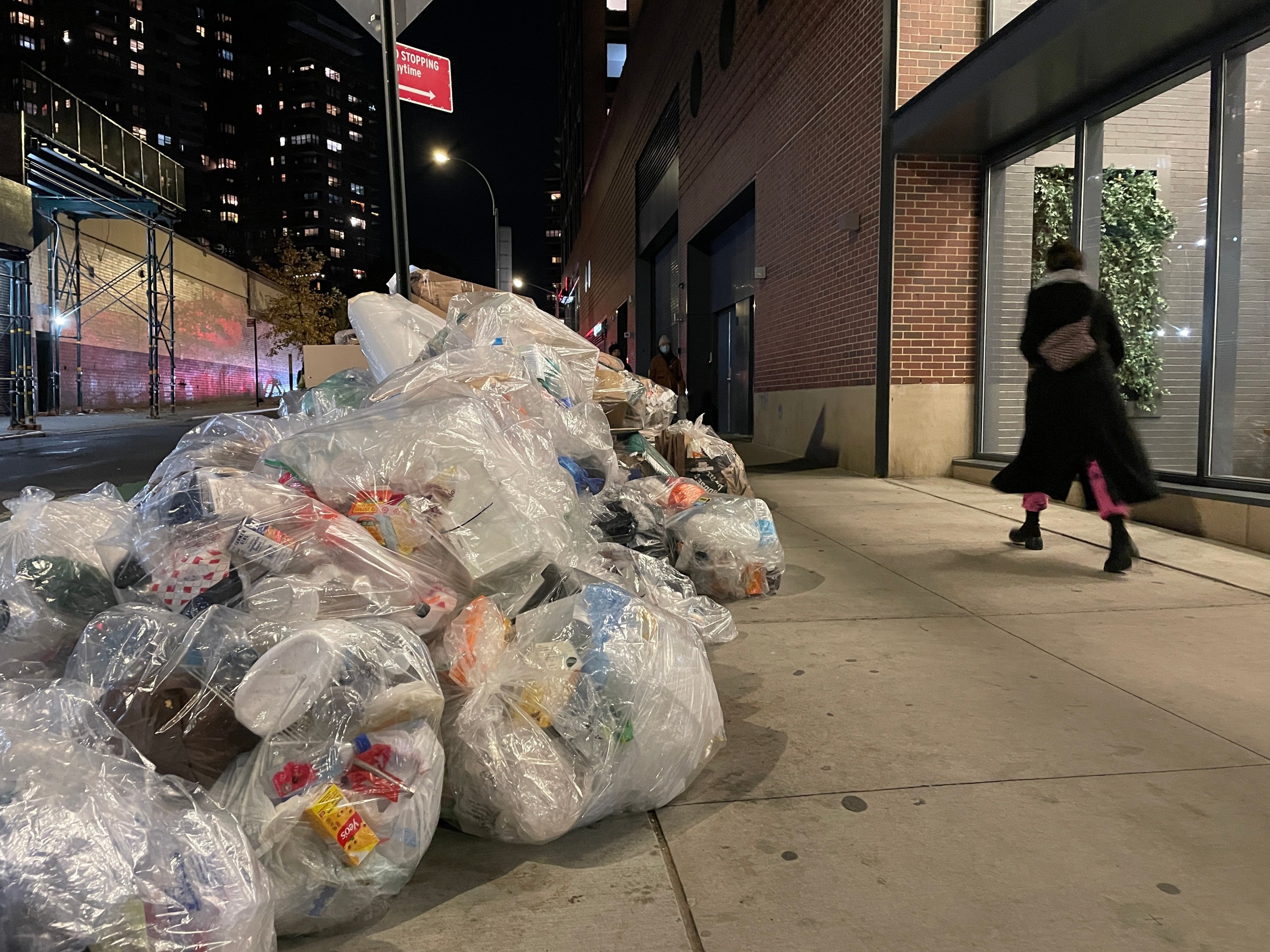 A giant pile of trash on the sidewalk.