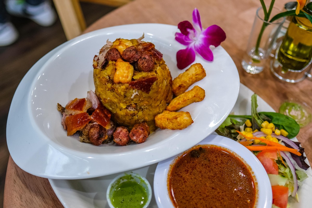 Mofongo Rinconcito with pernil, longaniza, fried queso, and dipping sauce.