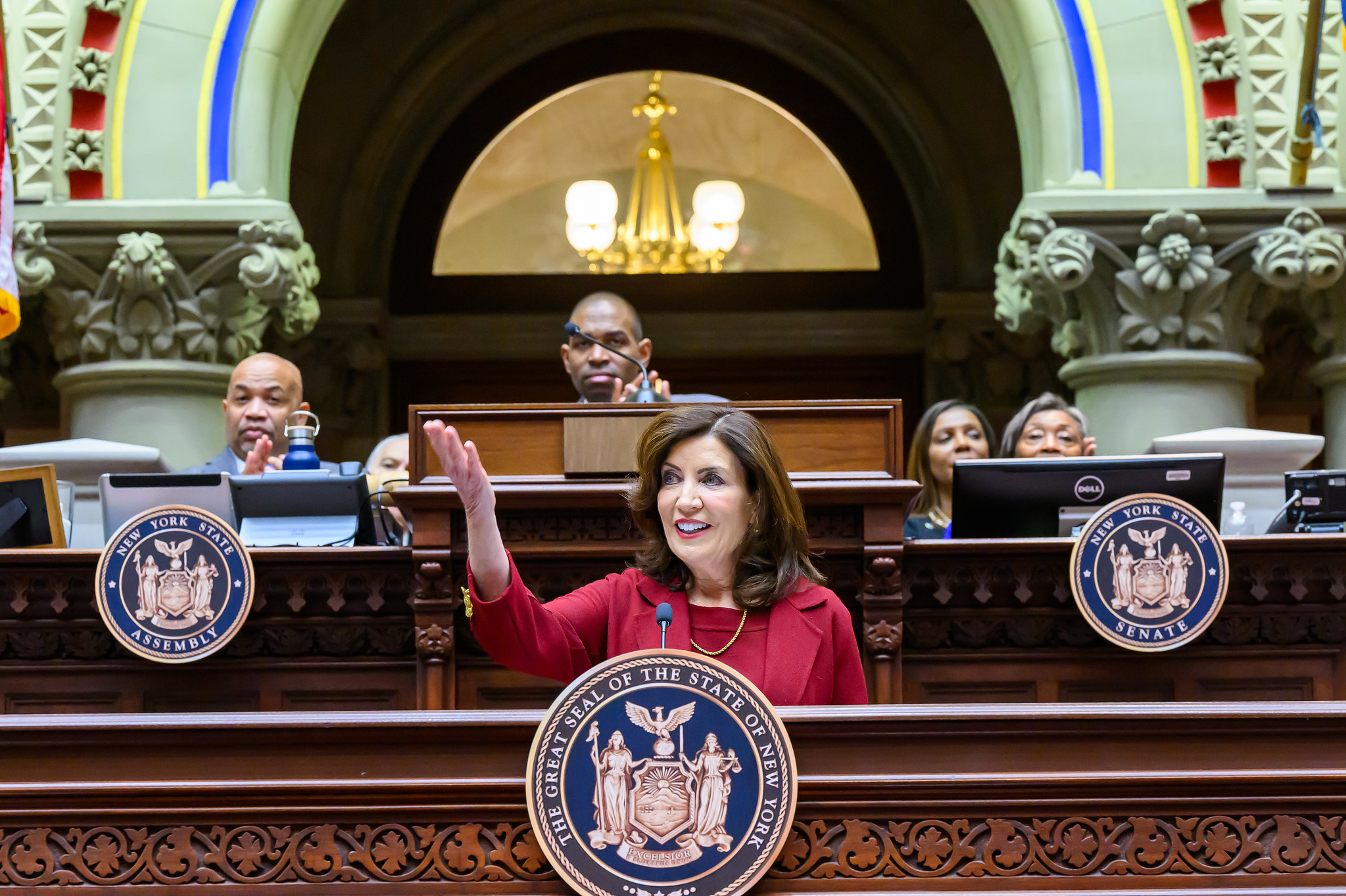 Governor Hochul at the podium, arm raised, giving the 2024 state of the state speech.