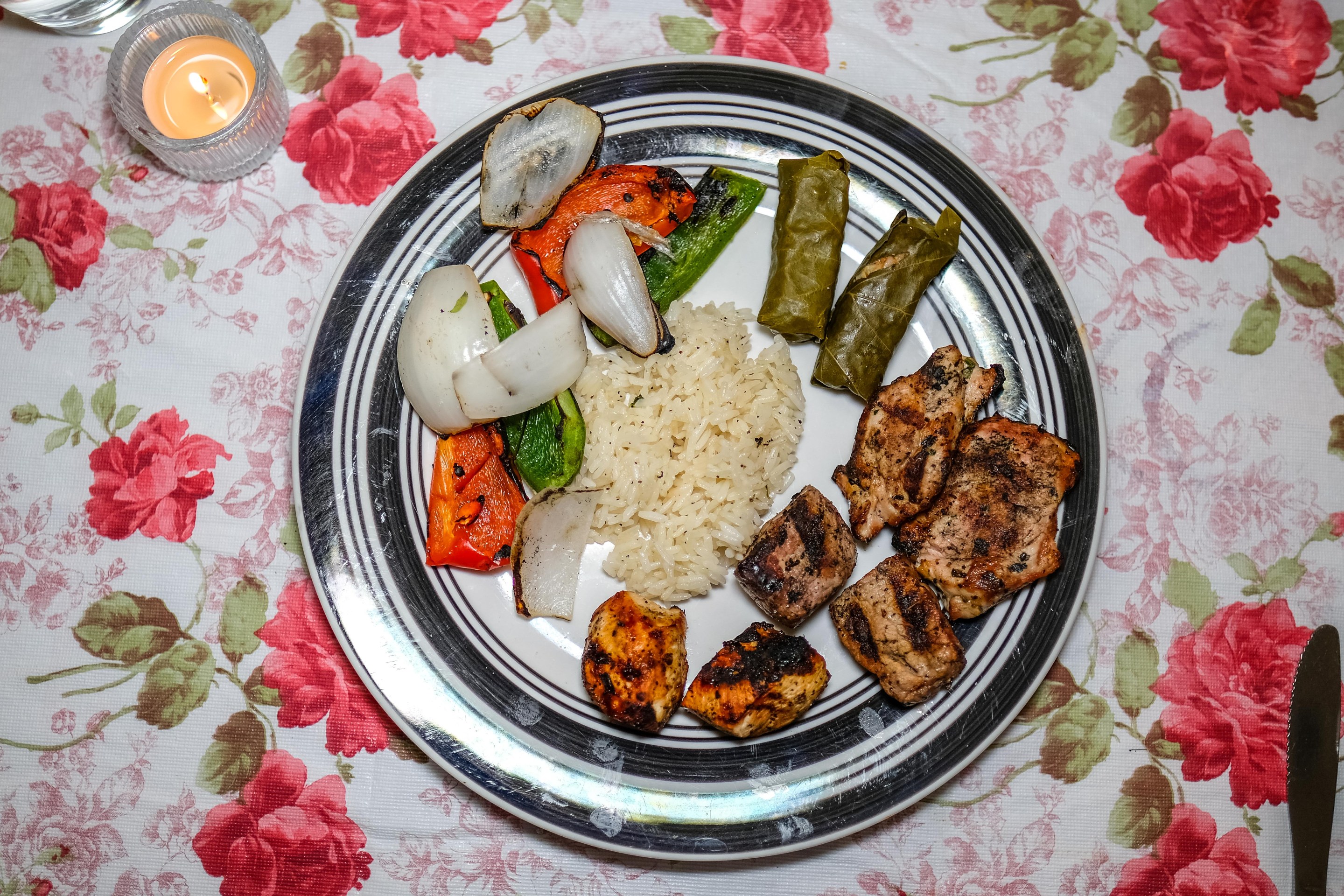 Armenian plate with roast meats and stuffed grape leaves.