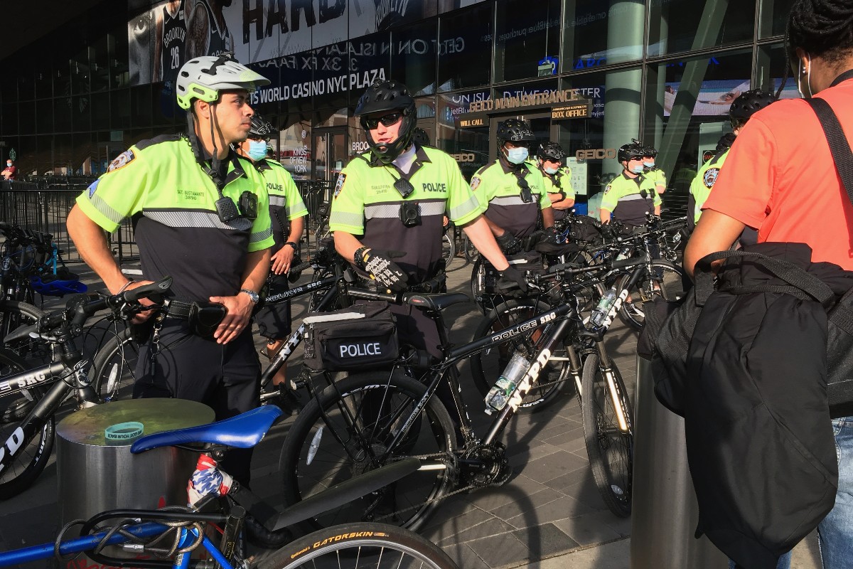 SRG NYPD officers on bikes wait outside of a protest.