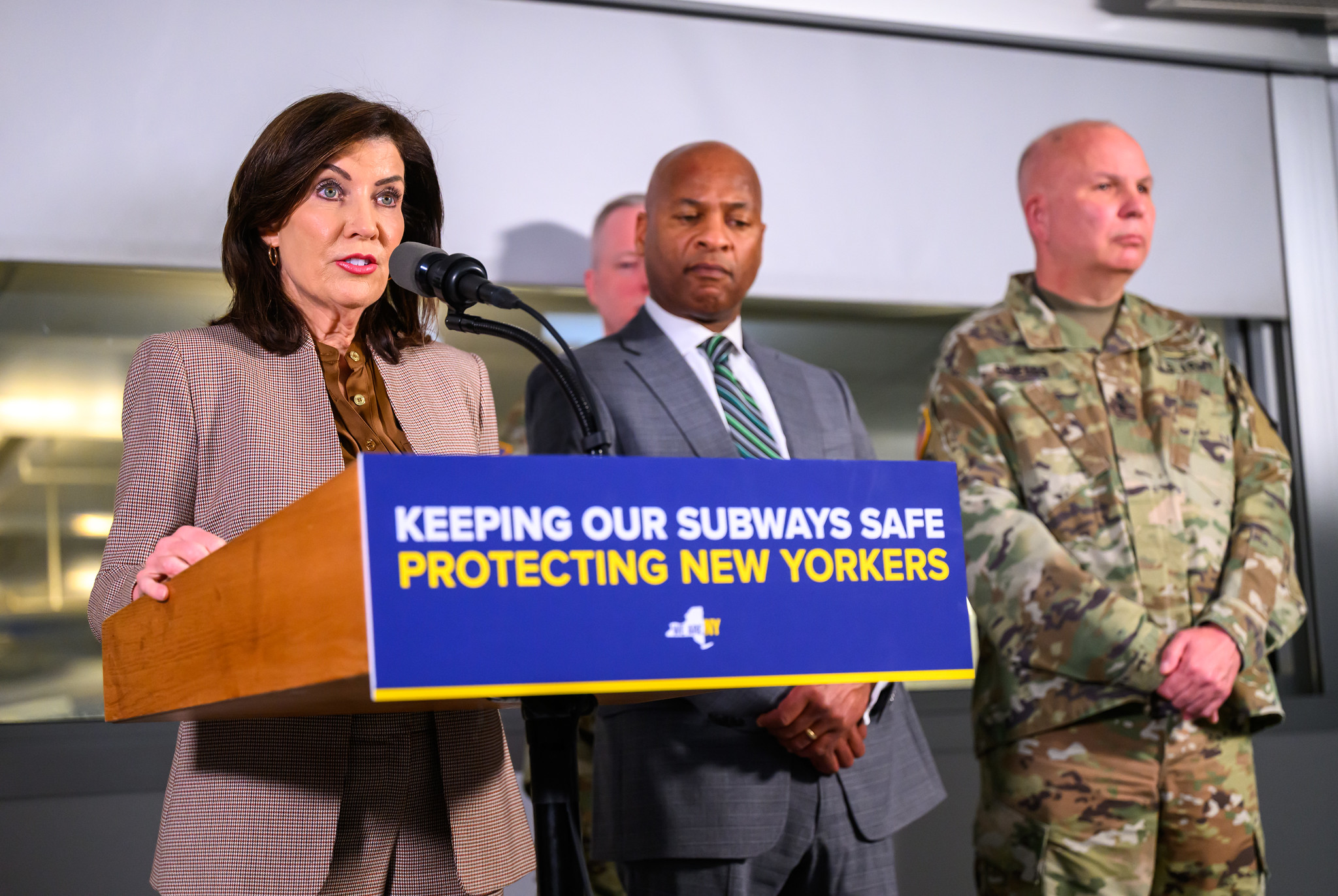 Governor Kathy Hochul stands at a podium that says "Keeping our subways safe protecting New Yorkers"