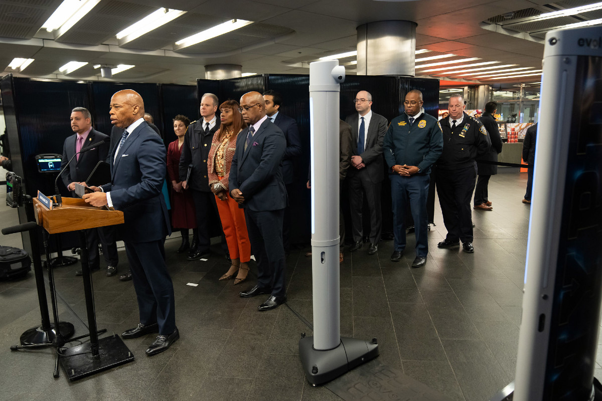 Eric Adams and his senior leadership team in the Fulton Street subway station posed next to an AI-powered weapons screening device